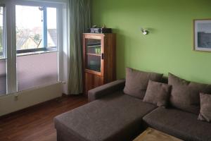 a living room with a couch and a window at Ferienwohnung Ortlieb Laboe in Laboe