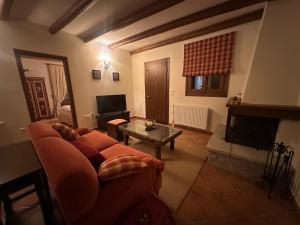 a living room with a couch and a fireplace at Nostalgia Guesthouse Arachova in Arachova