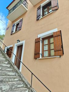 a building with two windows and a staircase at Nostalgia Guesthouse Arachova in Arachova