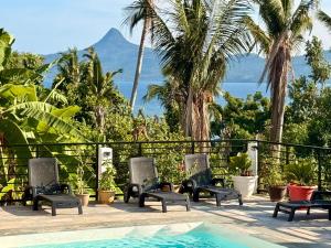 a pool with chairs and a view of the ocean at LE CHISSIOUA in Sada