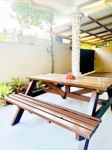 a wooden picnic table sitting on a patio at Friendly Waves Resort Arugambay in Pottuvil