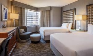 a hotel room with two beds and a chair at Hyatt Regency Saint Louis at The Arch in Saint Louis +66 photos