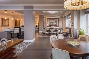 a dining room and living room with a table and chairs at Hyatt Regency Saint Louis at The Arch in Saint Louis