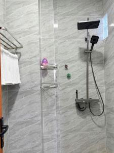 a shower with a glass door in a bathroom at HOMESTAY- Hưng Thịnh in Vạn Ninh