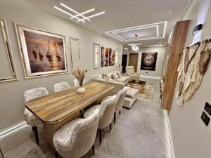 a dining room with a table and chairs at Arabella Residence 3BR - New Cairo Luxury Serviced Apartments in Cairo