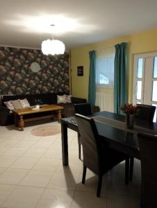 a living room with a table and a couch at Vila Sabo in Sîntioana +10 photos