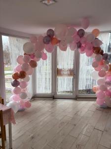 a bunch of balloons hanging in a room at Villa Siret in Galaţi