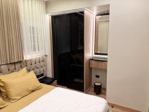 a bedroom with a bed with a mirror and a television at Arabella Residence 3BR - New Cairo Luxury Serviced Apartments in Cairo