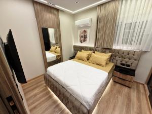 a bedroom with a large bed and a mirror at Arabella Residence 3BR - New Cairo Luxury Serviced Apartments in Cairo