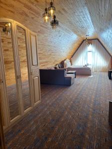 a room with a couch and a bed in a building at Şəki Yaylası Hotel in Sheki