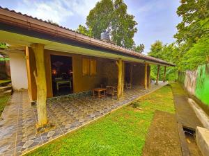 a house with a patio and a yard at Elephant paradise Safari lodge in Udawalawe