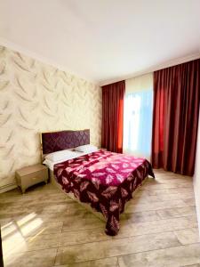 a bedroom with a bed with a purple blanket at Qax home in Qax +3 photos