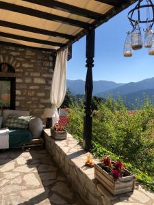 a patio with a bed and a view of the mountains at ΤΟ ΑΡΧΟΝΤΙΚΟ in Kríkellon +36 photos