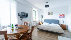 a living room with a bed and a table and a tableablish at Wellocum in Serock