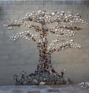 a tree made out of shells on a wall at Ama's Self Catering in Windhoek +4 photos