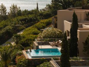 a view of a swimming pool in a villa at Phāea Blue - Small Luxury Hotels of the World in Elounda +112 photos