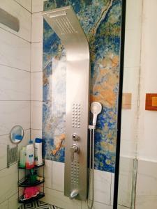 a shower door in a bathroom with a map on the wall at Greek Style Bed & Breakfast in Al Manashsh +4 photos