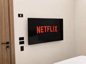 a tv on a wall with the netflix sign on it at Arabella Residence 3BR - New Cairo Luxury Serviced Apartments in Cairo +37 photos