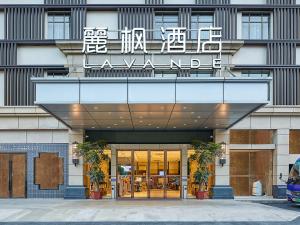 a building with a sign on the front of it at Lavande International Hotel Guangzhou Baiyun International Airport Renhe Metro Station Branch - Free Shuttle Bus to Guangzhou Baiyun International Airport in Guangzhou