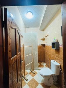 a bathroom with a toilet and a shower at Natural Surf Morocco in Tamraght Ouzdar +78 photos