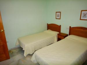 two beds in a small room with white walls at Bertur San Antonio Mar in Alcossebre +56 photos