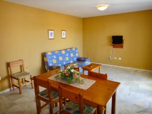 a living room with a couch and a table and a chair at Bertur San Antonio Mar in Alcossebre