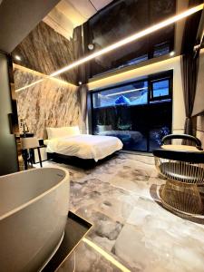 a bedroom with a bed and a large window at 델루나호텔 부평점 in Incheon