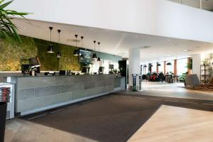 a lobby of a restaurant with a counter at Scandic Lerkendal in Trondheim