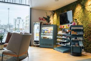 a store interior with a refrigerator and a chair at Scandic Lerkendal in Trondheim