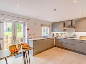 a kitchen with a table with fruit on it at 3 Bed in Harrogate oc-93305 in Summer Bridge +14 photos
