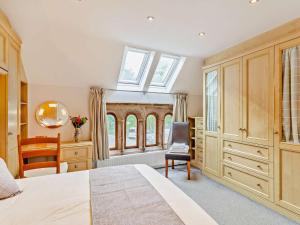 a bedroom with a bed and a desk and a window at 3 Bed in Harrogate oc-93305 in Summer Bridge