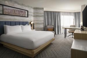 a hotel room with a bed and a desk at DoubleTree by Hilton Fort Lee/George Washington Bridge in Fort Lee +18 photos