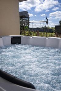 a water slide with a playground in the background at Le cocon de Jules et Chloé in Cléder +65 photos