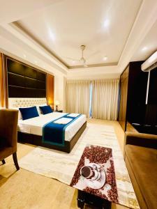 a bedroom with a bed and a couch and a television at Sea view Serenity Negombo in Negombo +12 photos