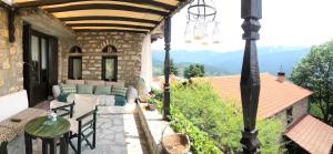 an outdoor patio with a couch and a table at ΤΟ ΑΡΧΟΝΤΙΚΟ in Kríkellon