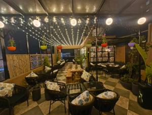 a restaurant with chairs and tables and potted plants at THE MASARA MANAR Hotel in Gwalior
