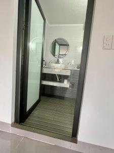 a bathroom with a mirror and a sink at Khách Sạn Long Dung in Nam Khê