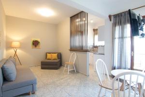 a living room with a couch and a table and a kitchen at Olga Villa in Megali Ammos