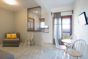 a living room with a table and chairs and a couch at Olga Villa in Megali Ammos