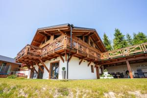 a house with a large deck on top of it at Chalet George in Zázrivá