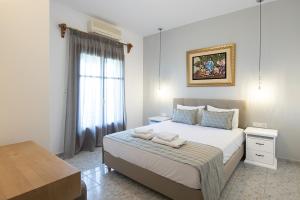 a bedroom with a bed with two towels on it at Olga Villa in Megali Ammos