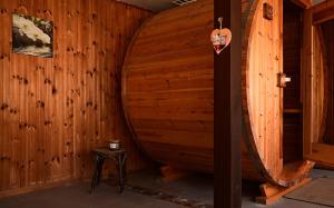 a large wooden room with a large wooden barrel at Cosy farmhouse with sauna in Sint-Truiden
