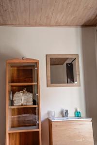 a room with a mirror and a wooden cabinet at Cosy farmhouse with sauna in Sint-Truiden +22 photos