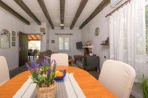 a dining room with a table and white chairs at House Sage in Tkon