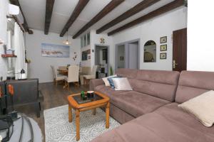 a living room with a couch and a table at House Sage in Tkon