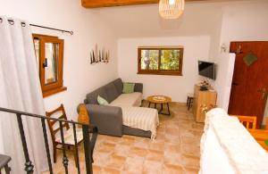 a living room with a couch and a tv at House Sarah in Tkon