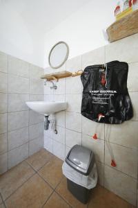 a bathroom with a sink and a bag on the wall at House Sarah in Tkon +36 photos