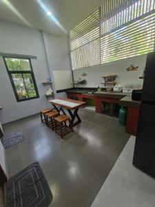 a kitchen with a table and chairs in a room at NaklangHillHouse in Ko Lanta Yai