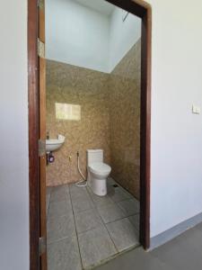 a bathroom with a toilet and a sink at NaklangHillHouse in Ko Lanta Yai +13 photos