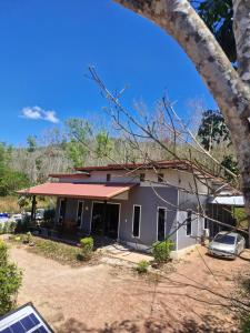 a house with a car parked in front of it at NaklangHillHouse in Ko Lanta Yai